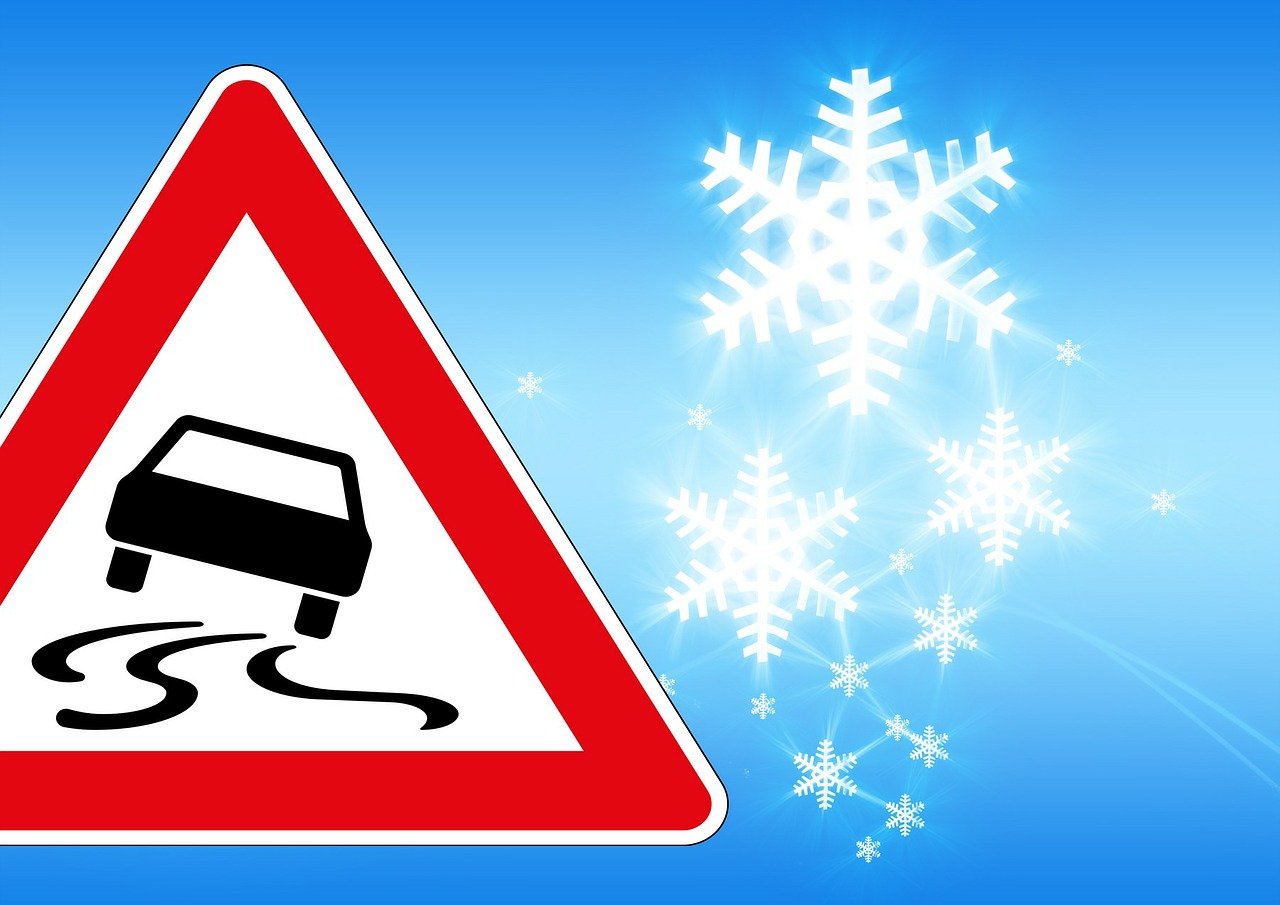 Warning signs because of black ice and winter background as symbol for the winter check on the car