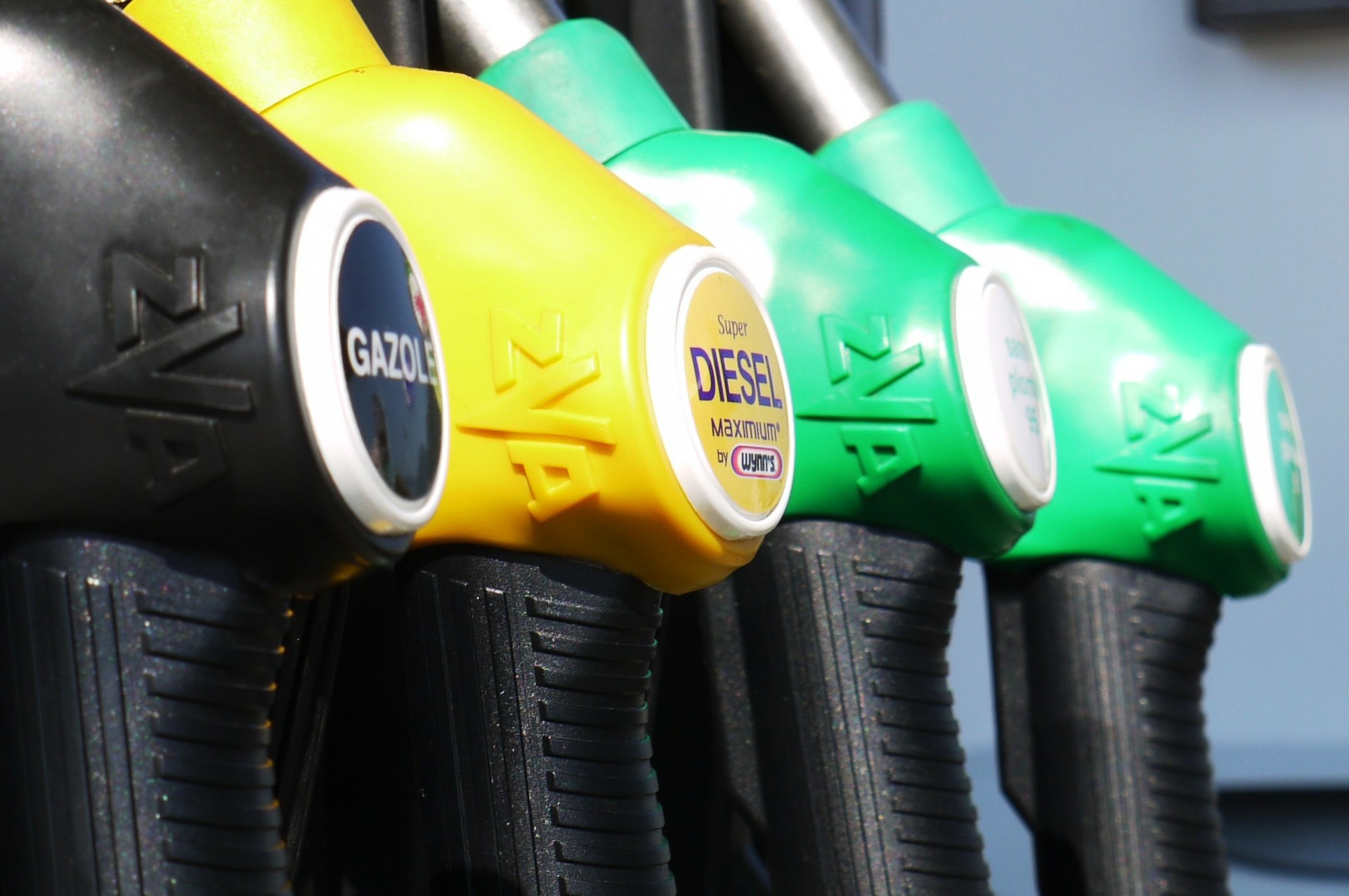 Nozzles at a filling station with different types of fuel